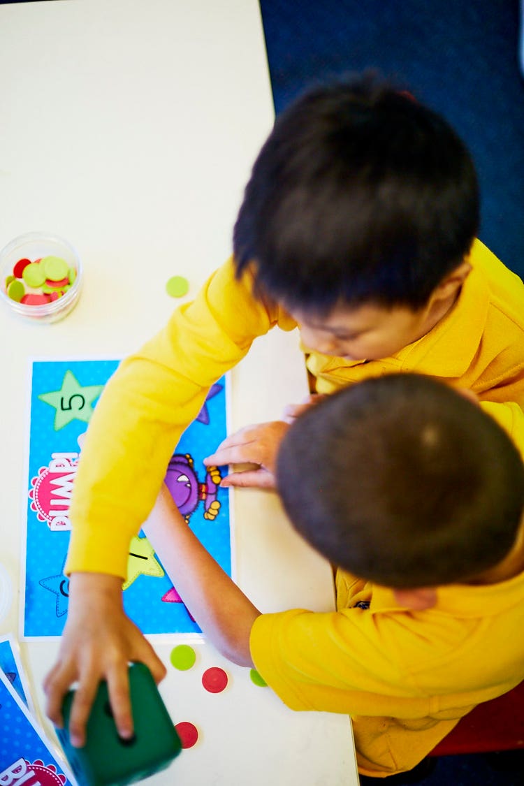 Image of two Kindergarten students playing a maths game